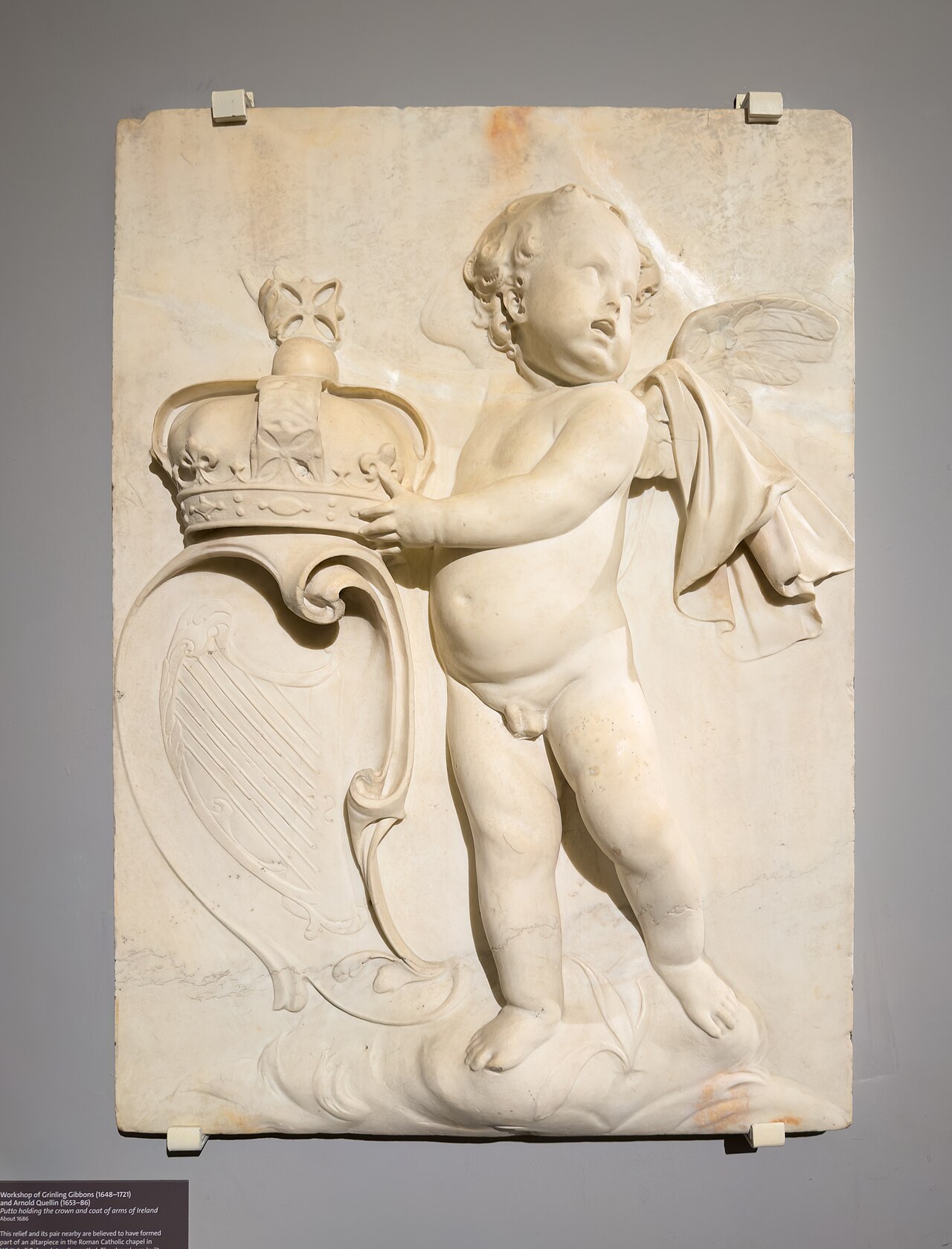 A Putto holding the Crown and coat of arms of Ireland by Artus Quellinus III
