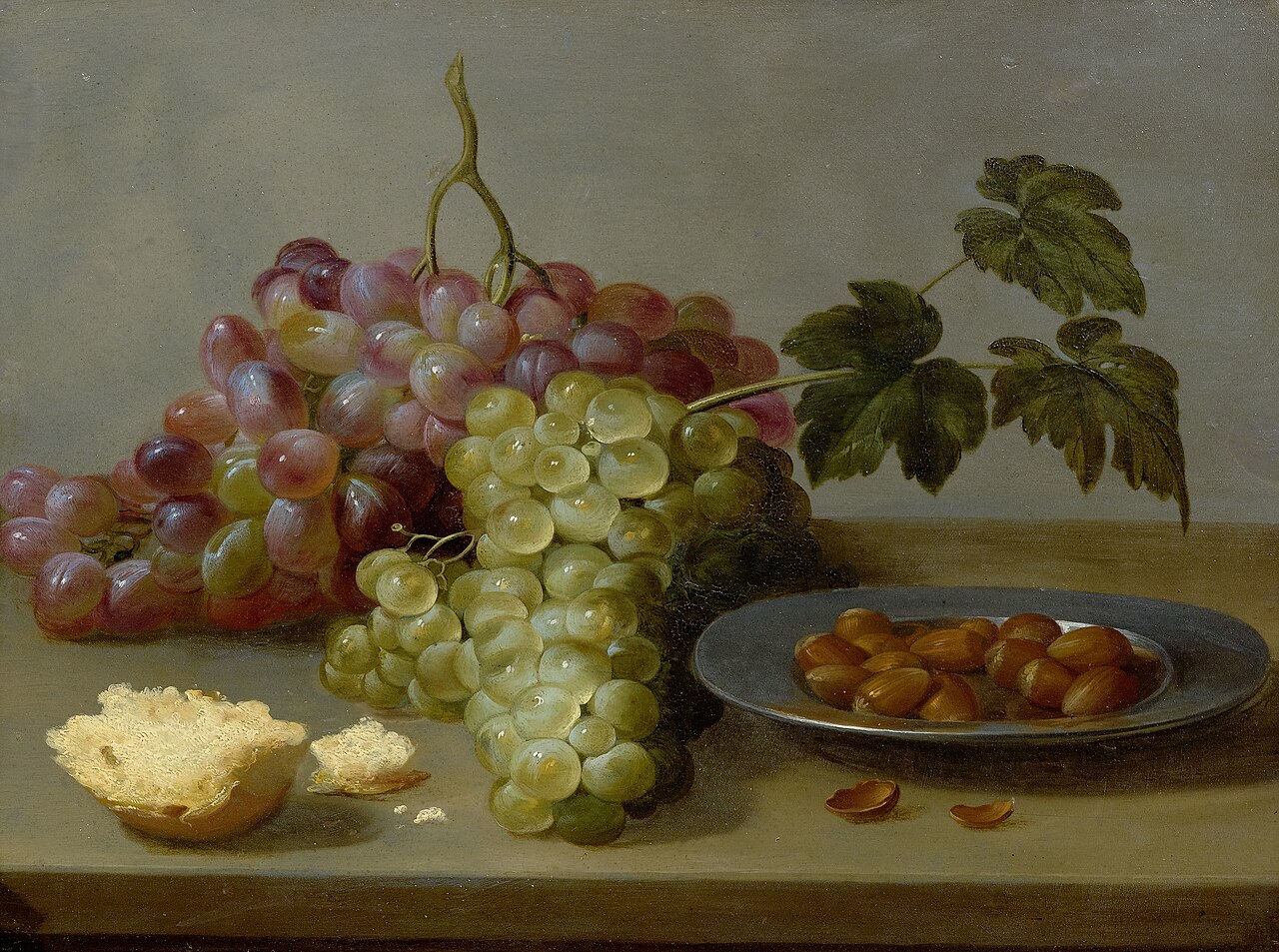 Still life with grapes and hazel nuts on a table by Jacob van Es