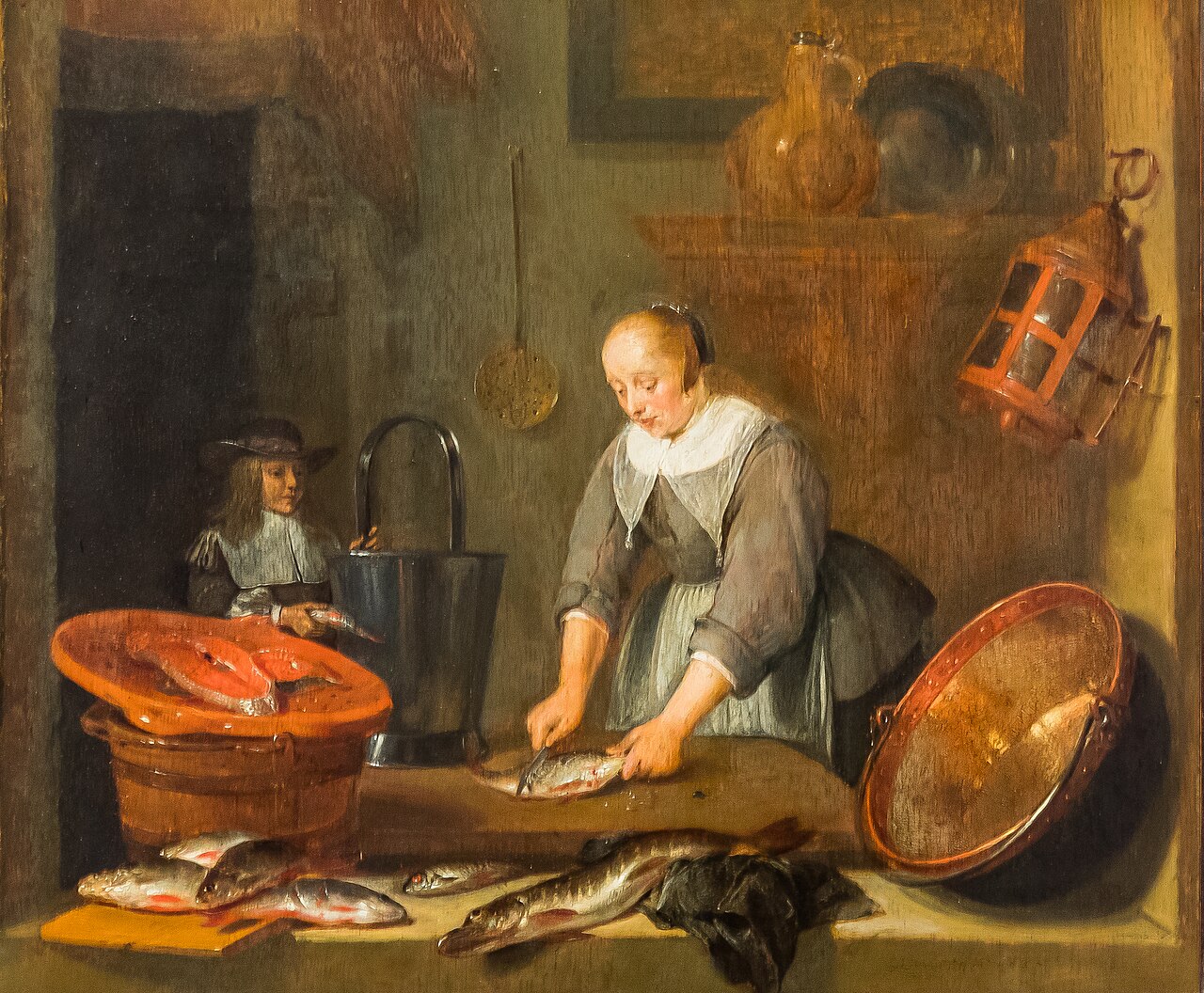 Interior with a woman cleaning fish and a boy with a fish by Quirijn van Brekelenkam