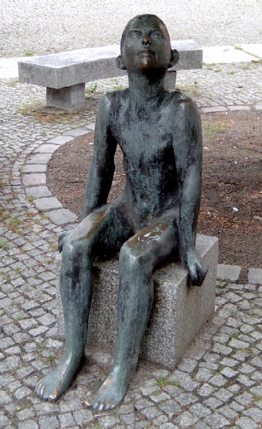 Sitting boy by Werner Stötzer